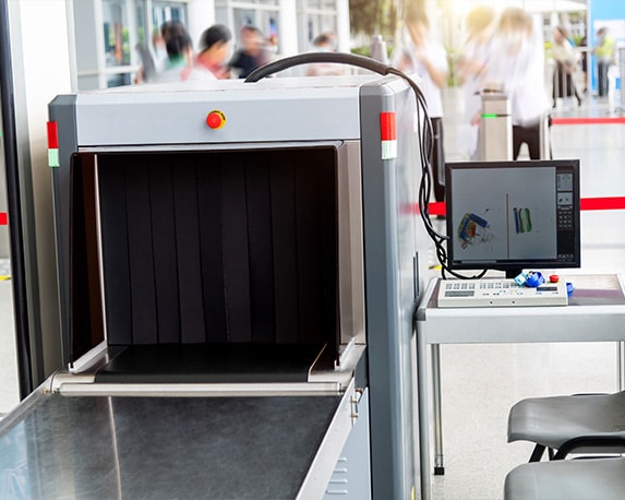 A baggage conveyor security belt connected to a computer on a desk