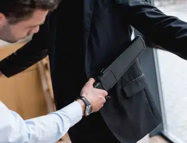Security guard with metal detector wand